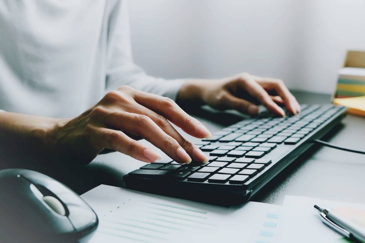 Female hands typing on a keyboard at MDCredentialing
