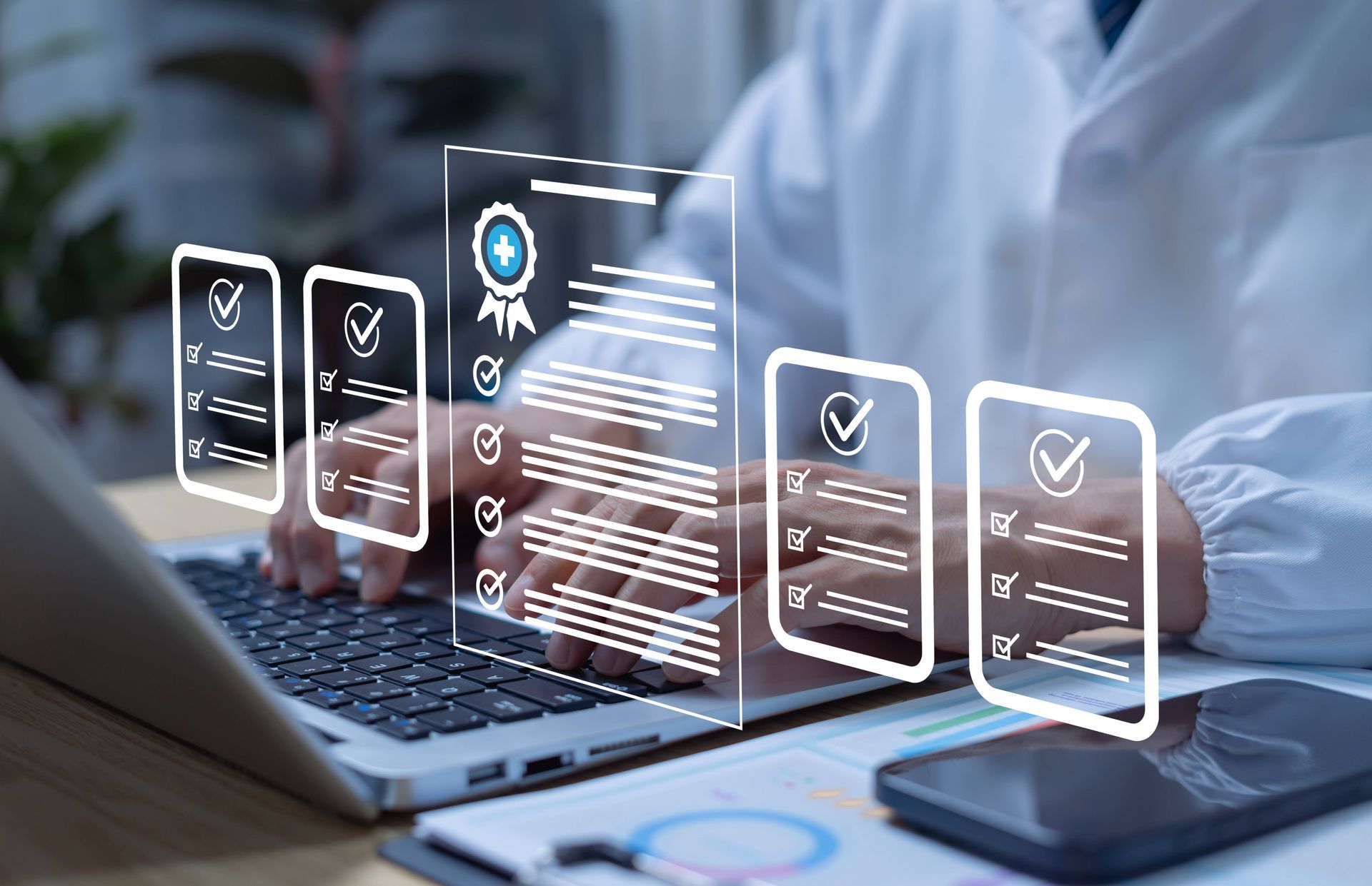 Medical professional typing on a laptop with graphics of pages in the foreground of the image.