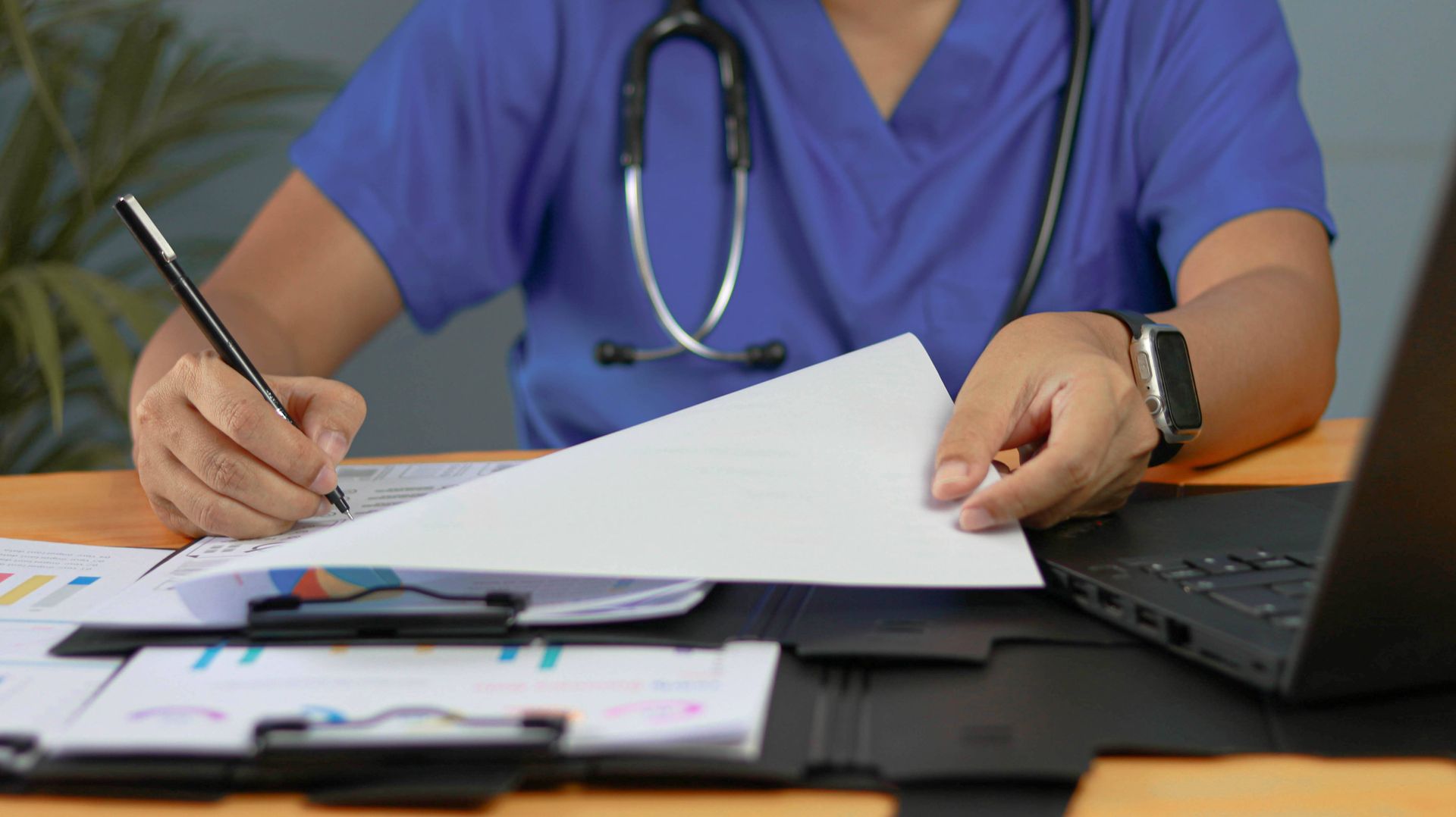 Medical worker looking over contracts.