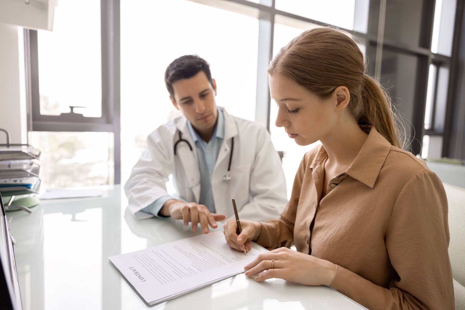 Physician talking with a woman over contracts.