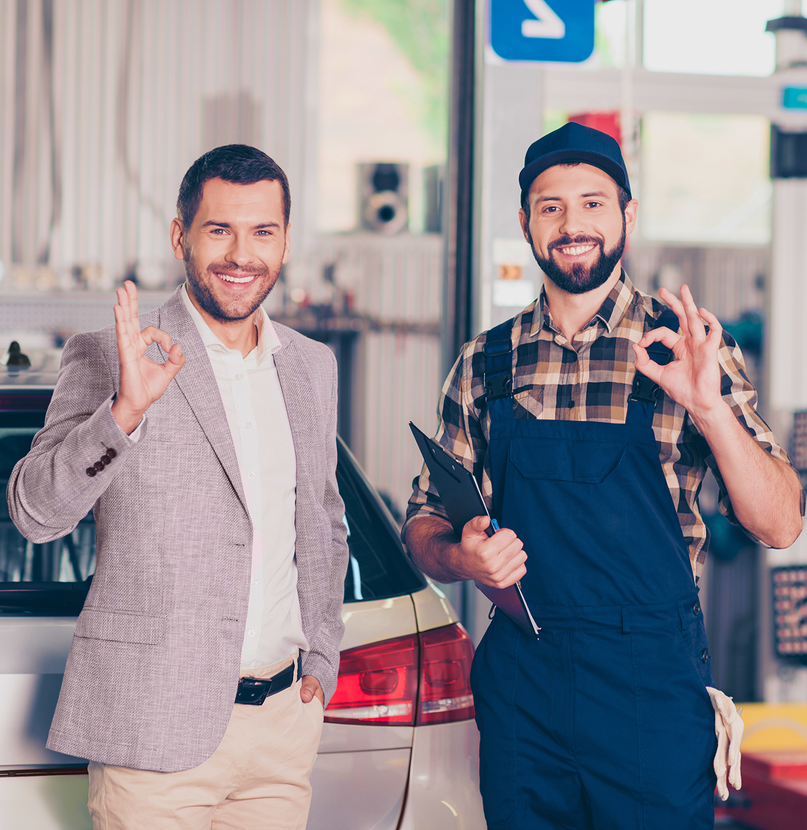 Man and mechanic smiling, giving