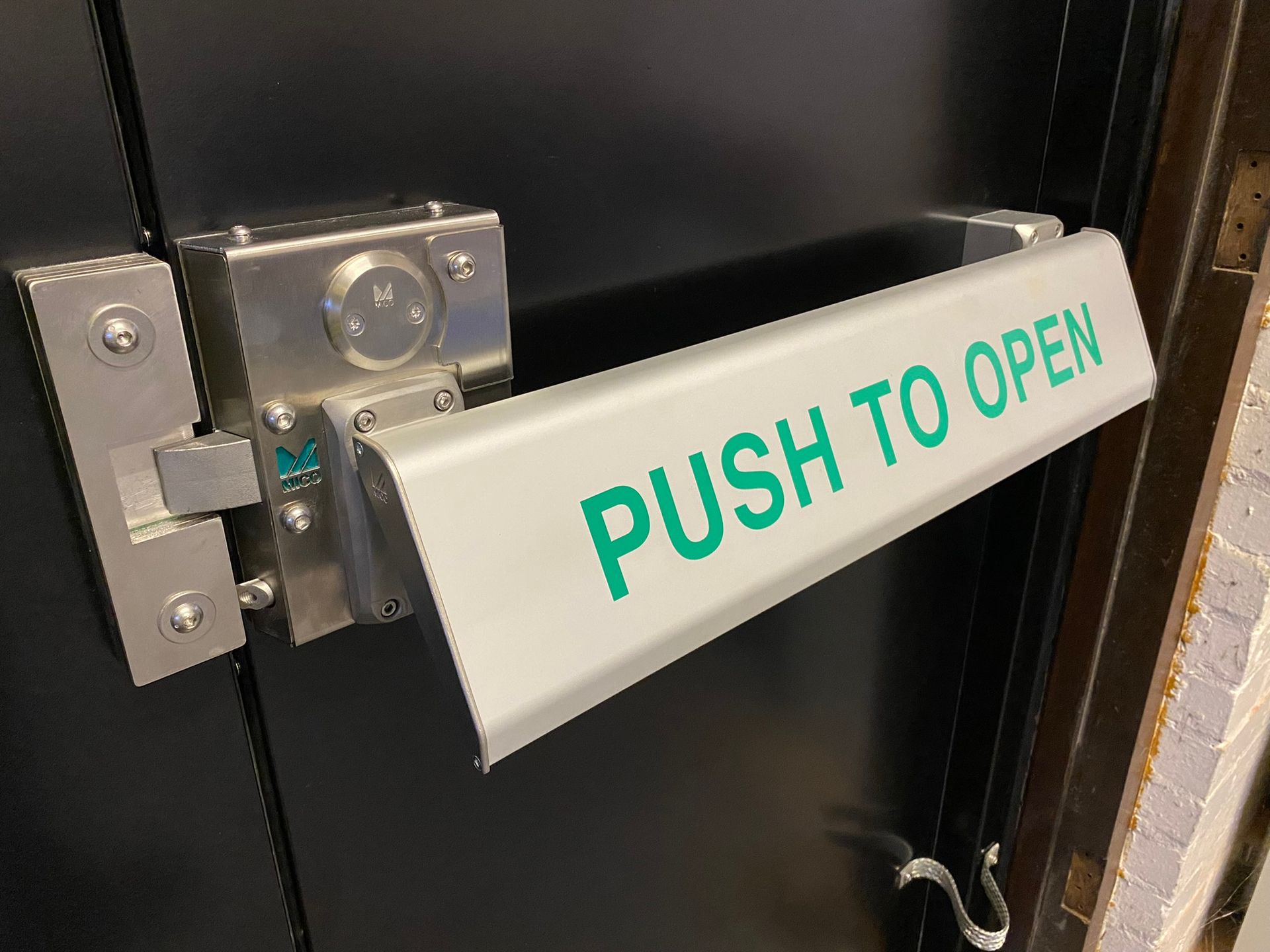 A door with a push to open sign on it