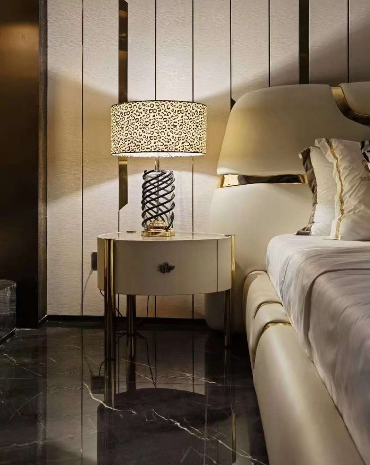A bedroom with a bed , dresser , lamp and wreath on the wall.