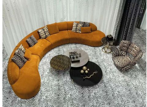 A bowl is sitting on a coffee table in a living room next to a couch.