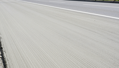 Fresh Ready Mix Concrete in Addis Ababa covers a smooth roadway surface, showing a fine textured finish across the slab.