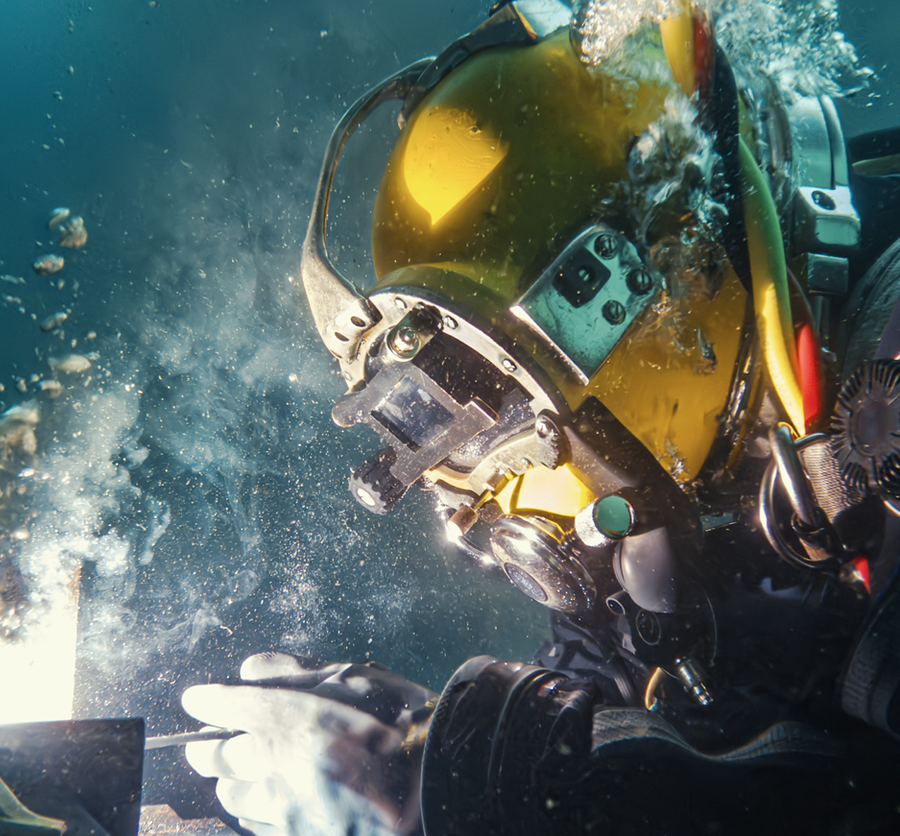 close up of a scuba diver welding underwater