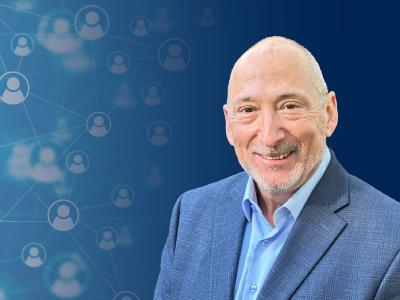 A headshot photo of Marty Ellner on a Navy blue graphic background