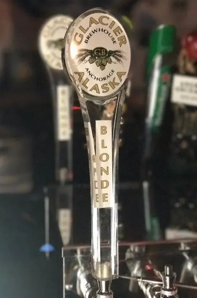 A close up of a beer tap that says glacier alaska on it