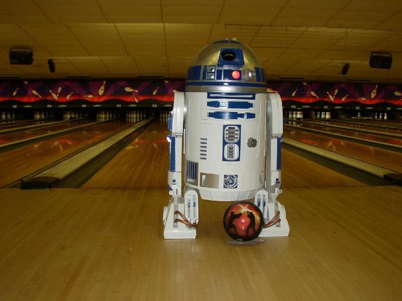 A group of people are playing bowling together in a bowling alley. A group of people are playing bowling together in a bowling alley.