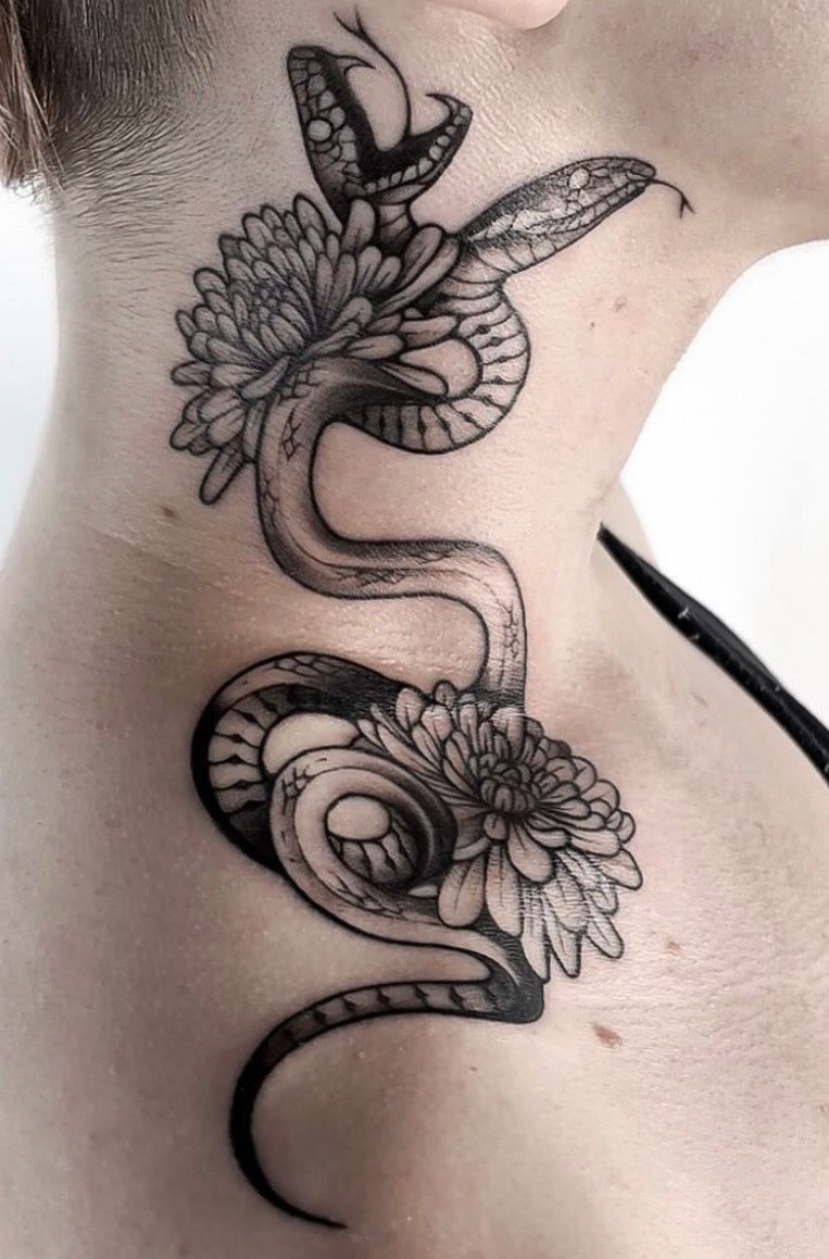 Black and gray snake tattoo by Jacy Andrew, featuring a winding serpent intertwined with chrysanthemum-like flowers along the side of the neck, with fine linework and detailed shading.