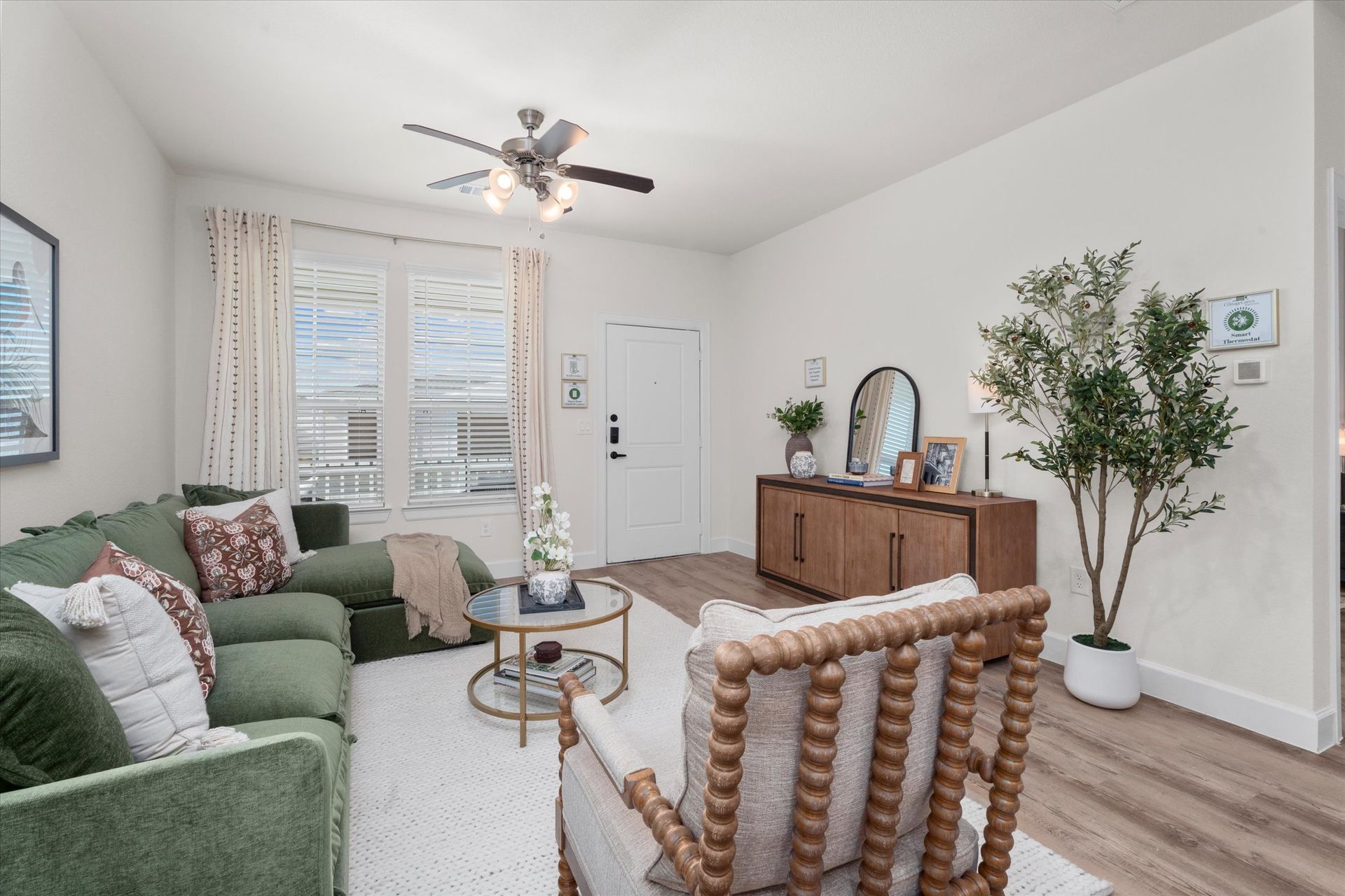 Open-concept living room in a modern apartment at The Cottage Green Baytown in Baytown TX