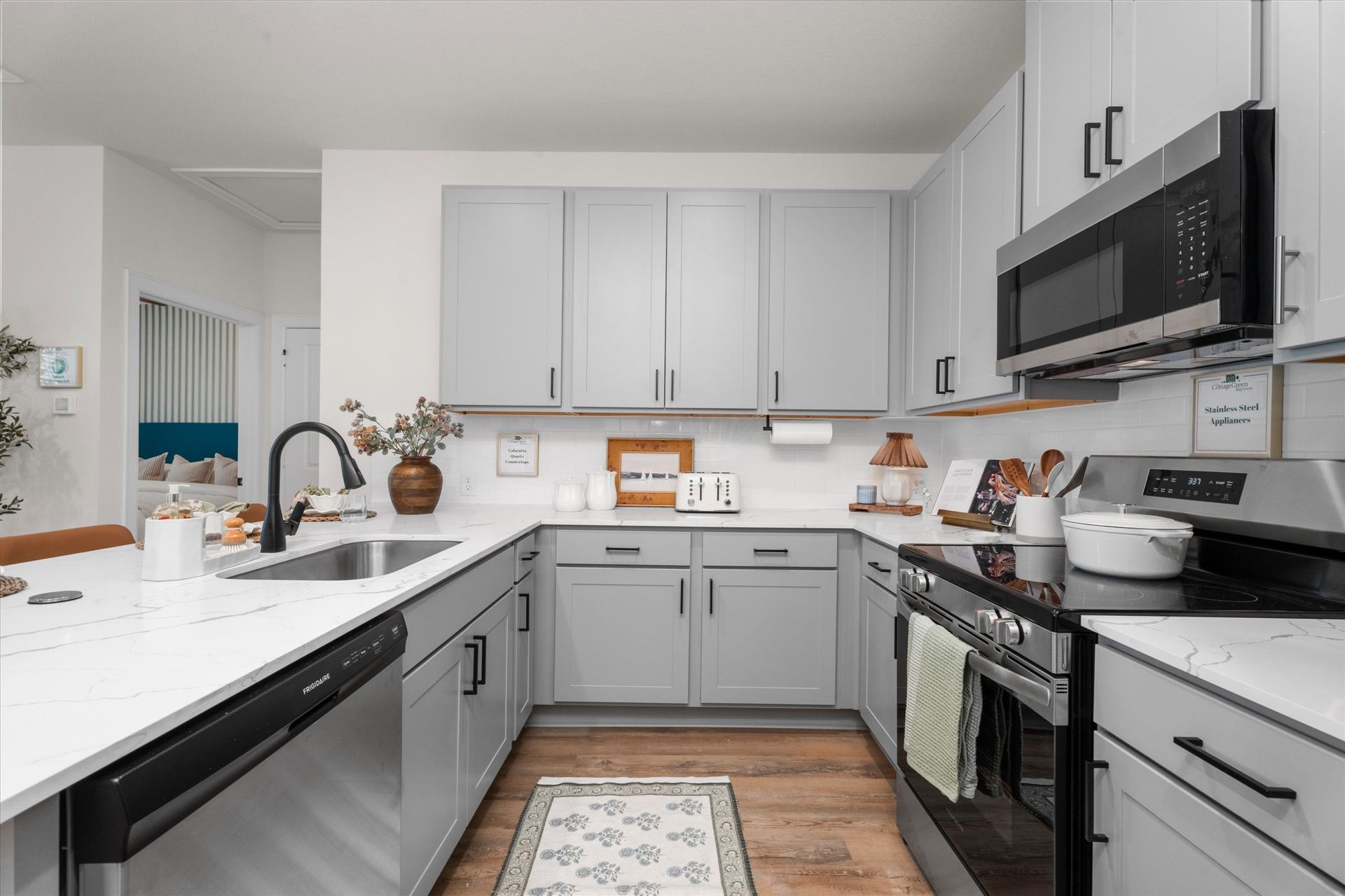 Modern kitchen with stainless steel appliances in a Baytown TX apartment at The Cottage Green