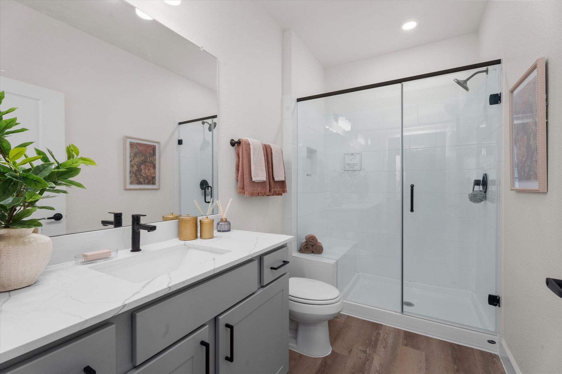Modern bathroom with walk-in shower at The Cottage Green Baytown apartments in Baytown TX