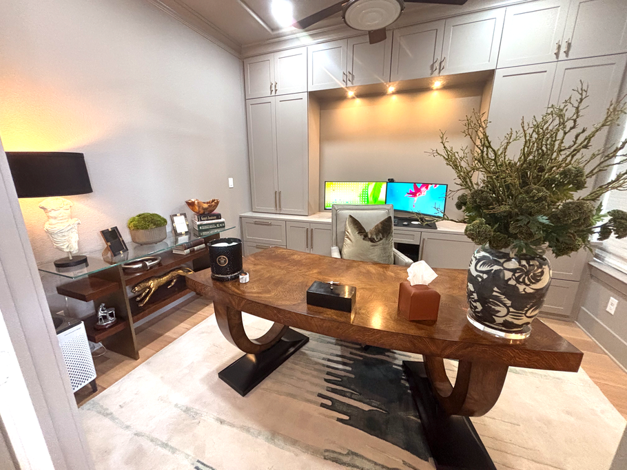 Modern living room with a wooden coffee table, sofa, TV, lamp, and potted plant near an arched wall niche