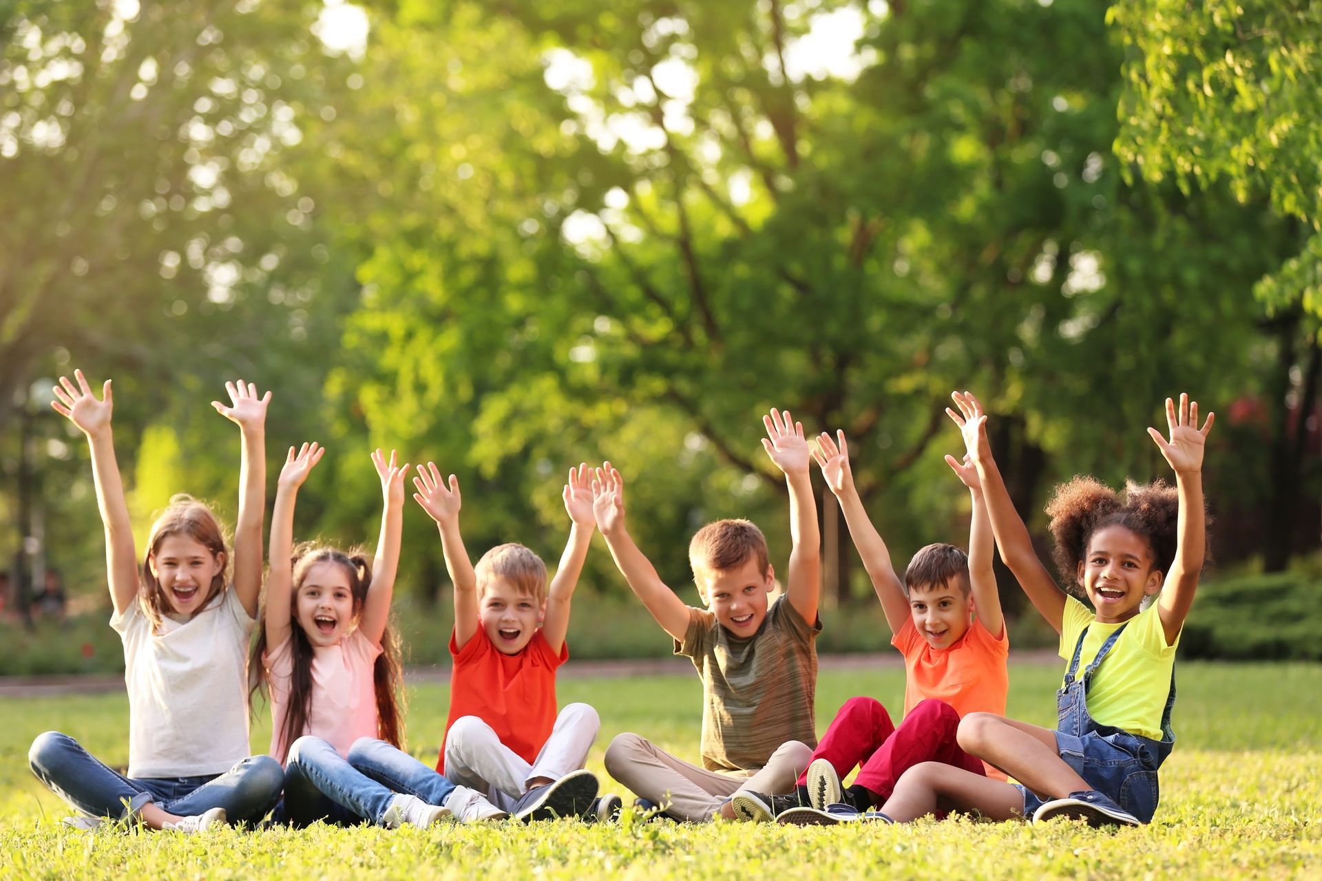 Children sitting on the grass.