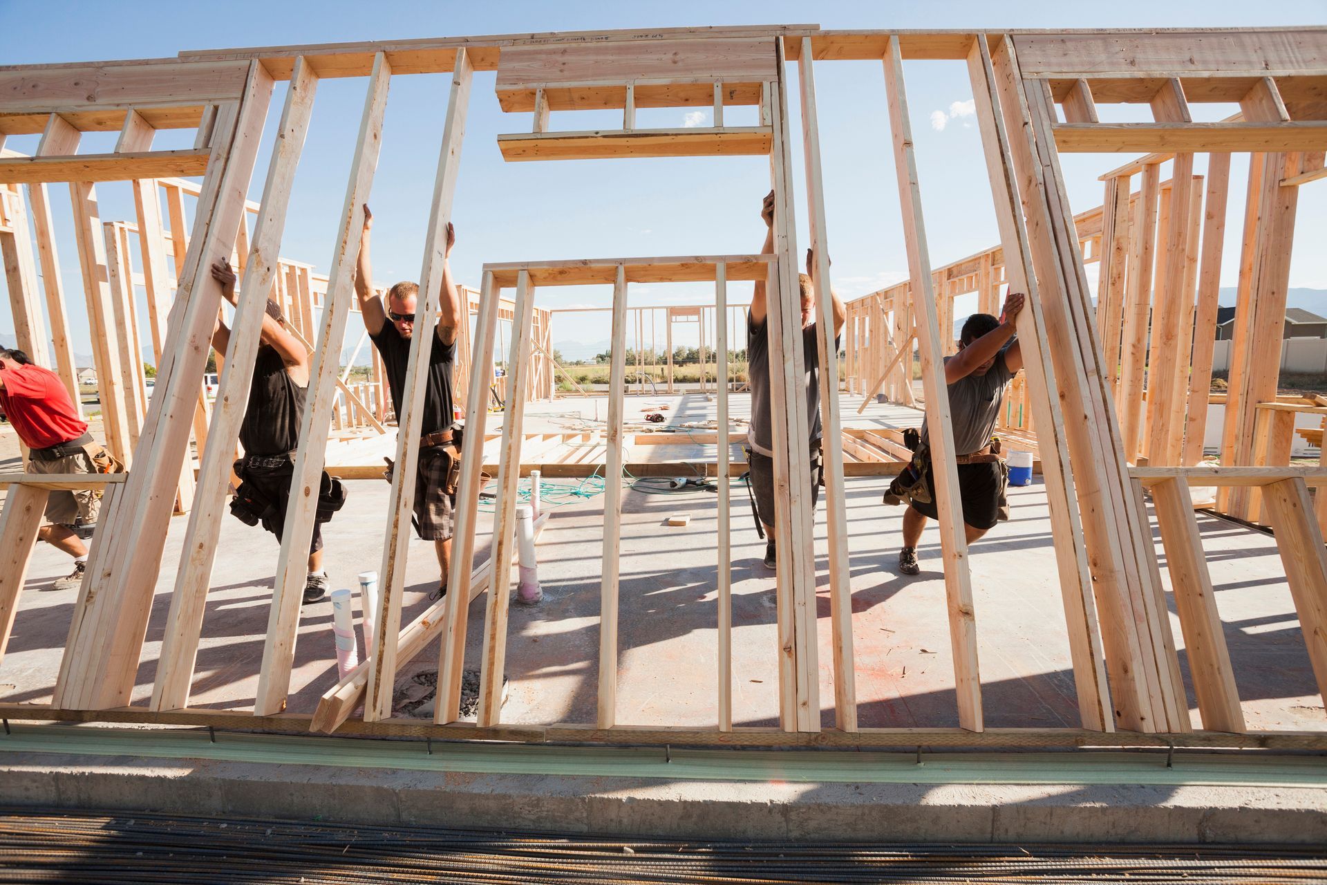 Workers are lifting the wall frame on the construction site. Workers are lifting the wall frame on the construction site.