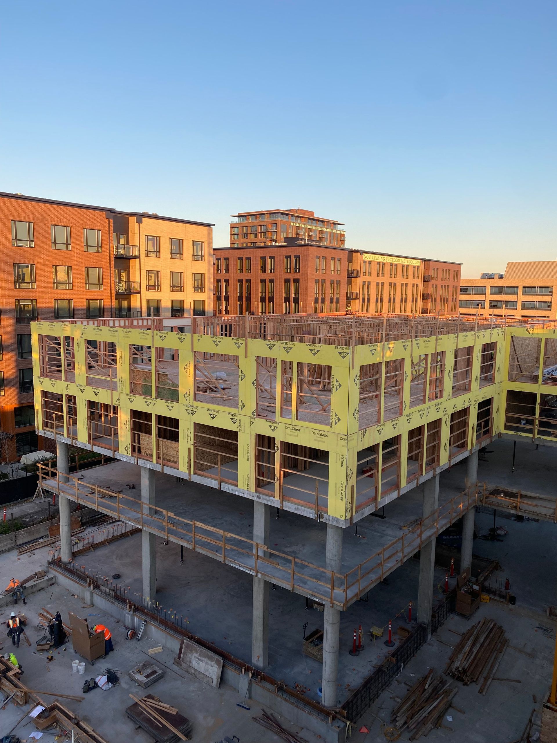 An aerial view of a building under construction in a city.