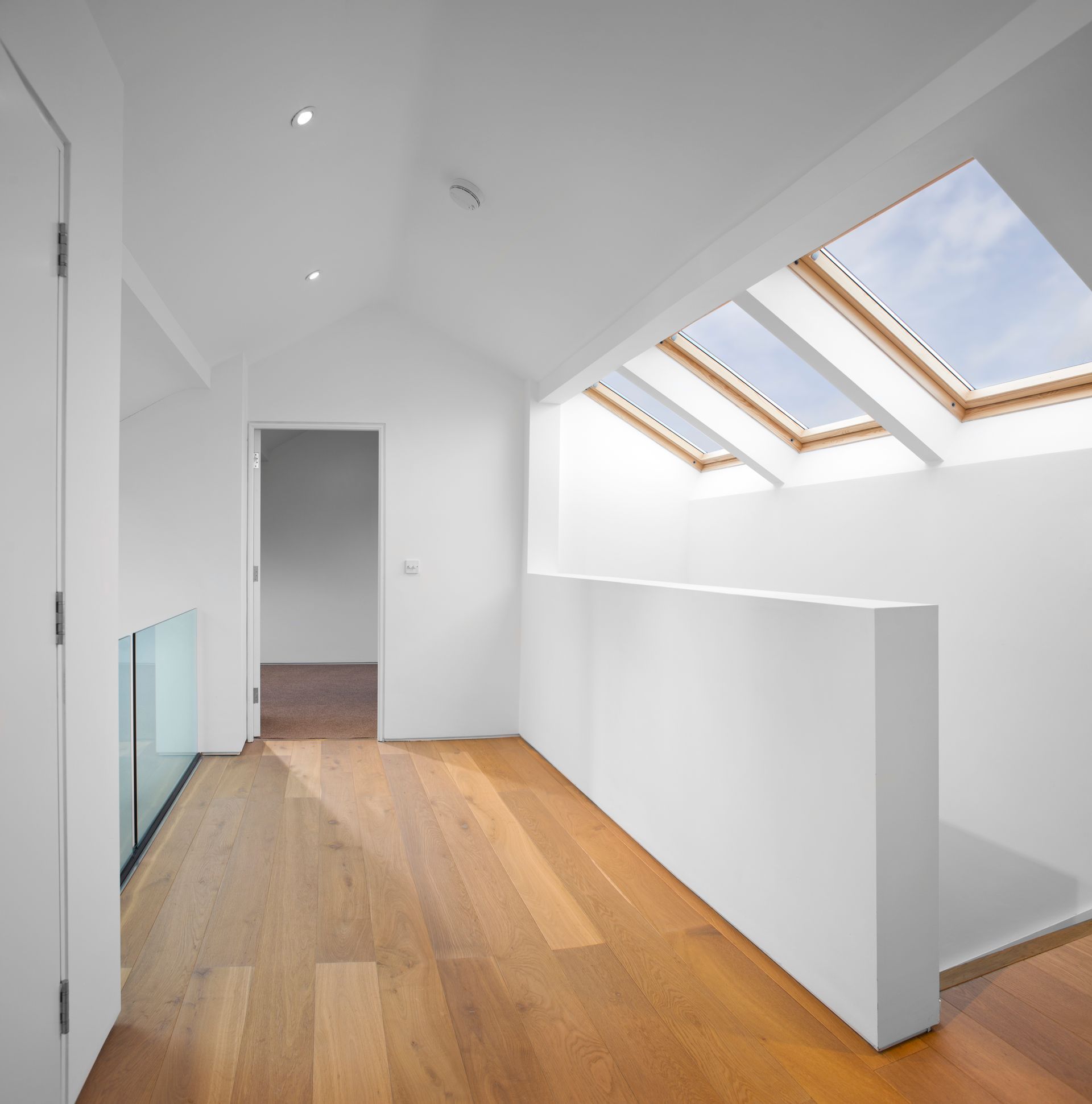 A hallway with a skylight in the ceiling