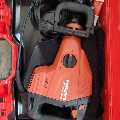 A red and black hilti hammer is in a red case