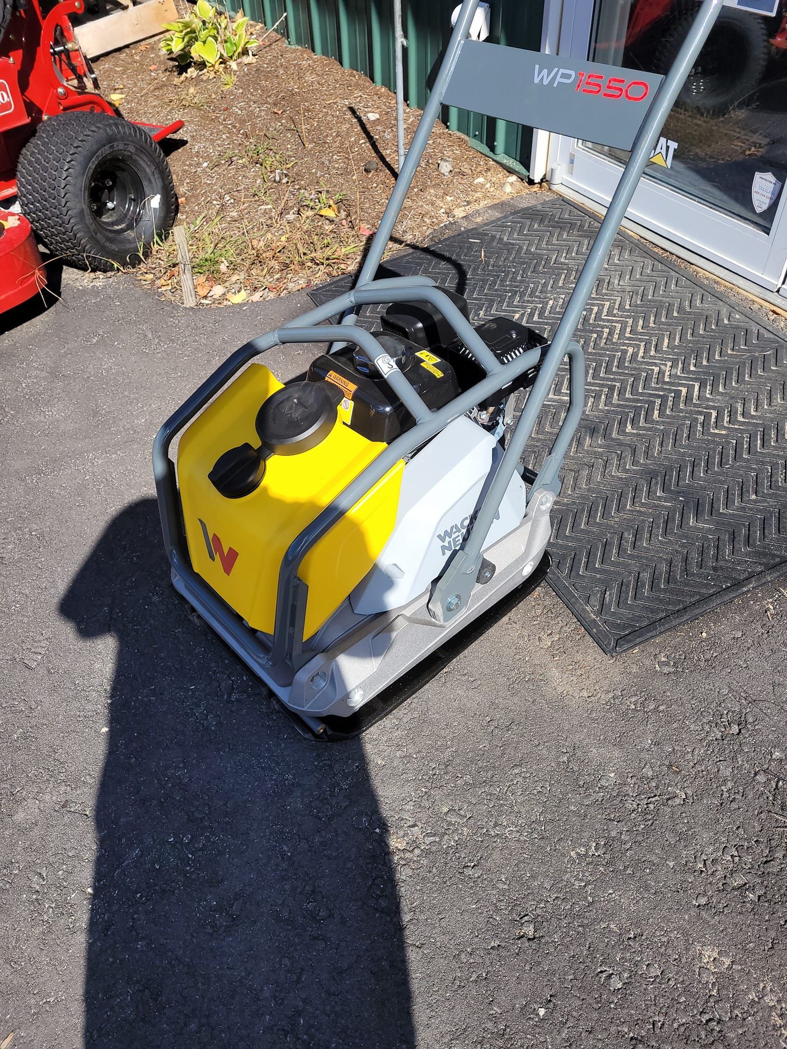 A yellow and white machine is sitting on the ground.