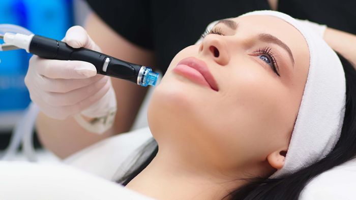 a woman is getting a facial treatment at a beauty salon