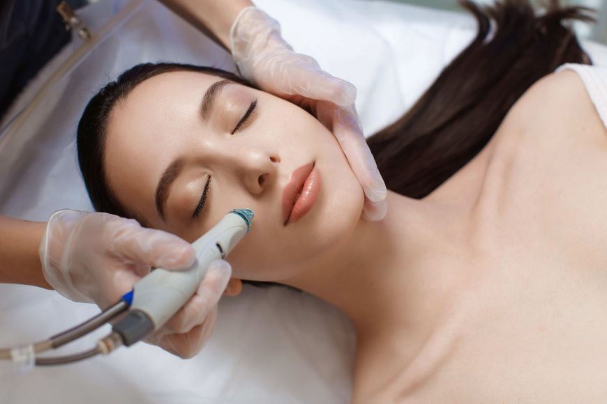 a woman is getting a facial treatment at a beauty salon