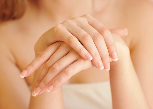 a close up of a woman 's hands with long nails