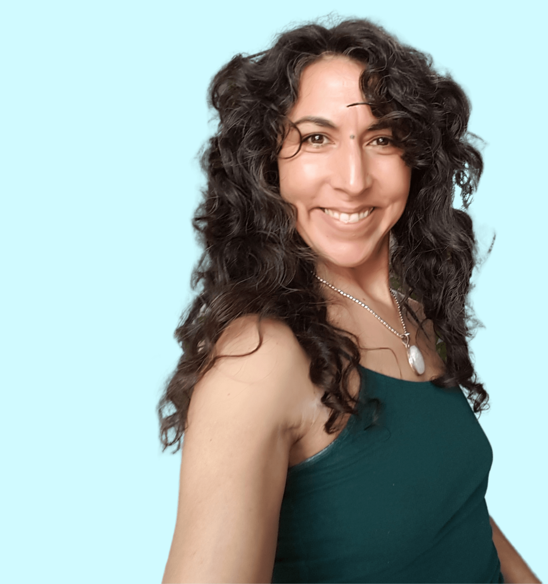 A woman with curly hair is wearing a green tank top and a necklace.