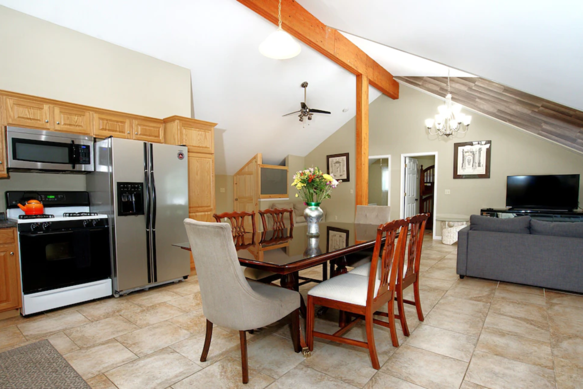 A kitchen with a table and chairs and a refrigerator