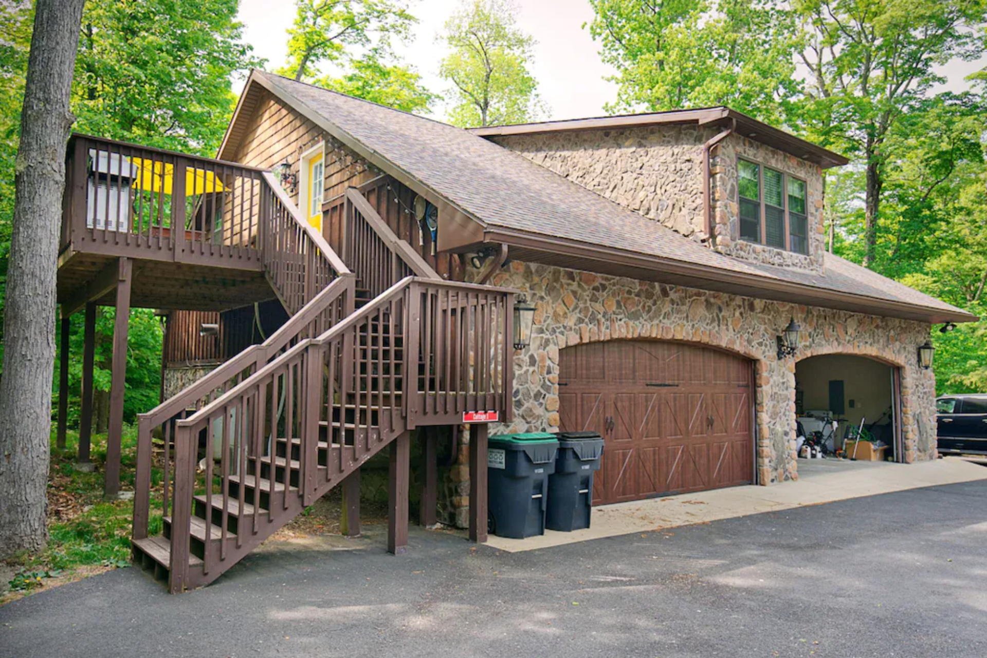 A house with a large garage and stairs leading up to it