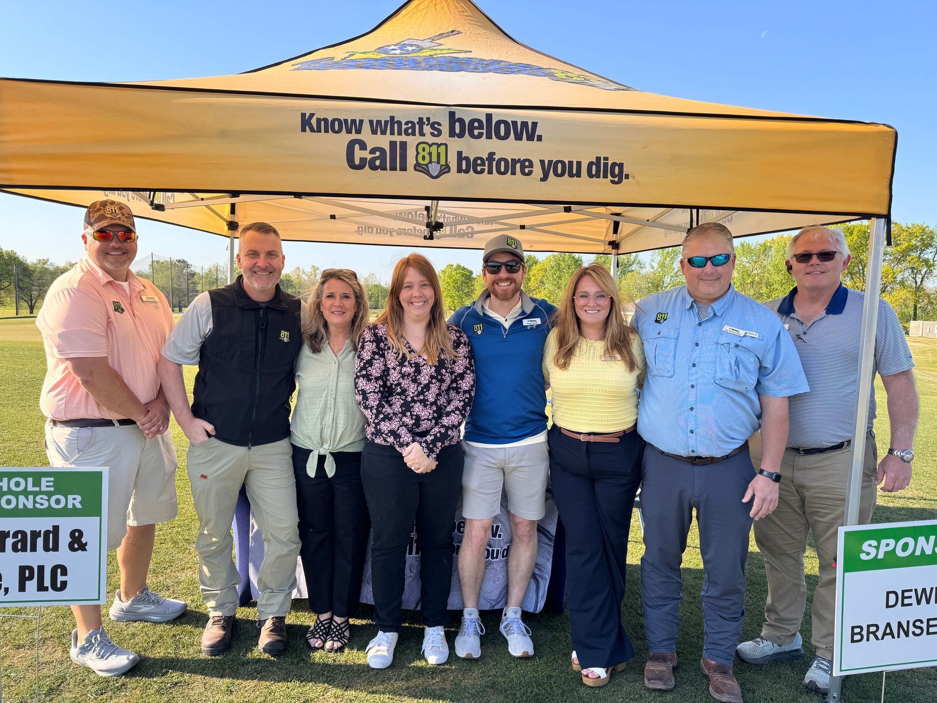 Staff standing under tent