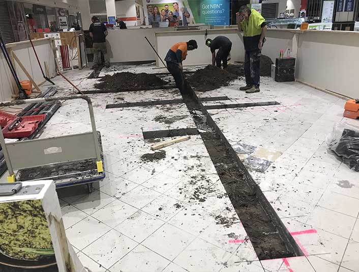 Electricians Installing Wiring In Building — Ceassa Electrical in Salamander Bay, NSW