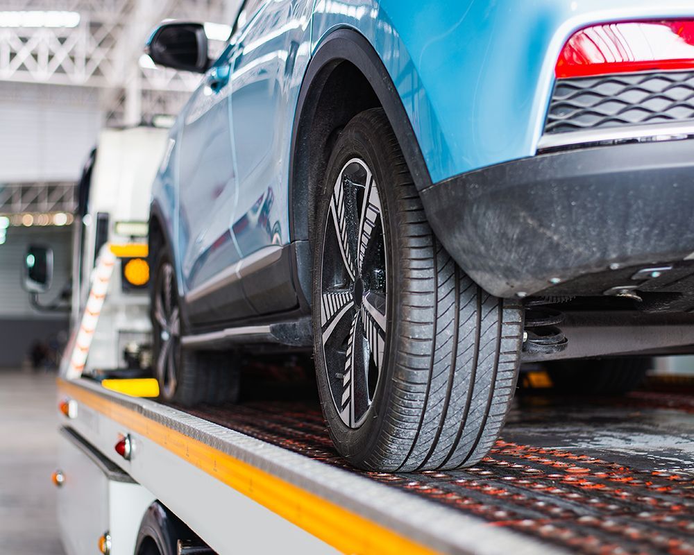 Blue Car on a Tow Truck