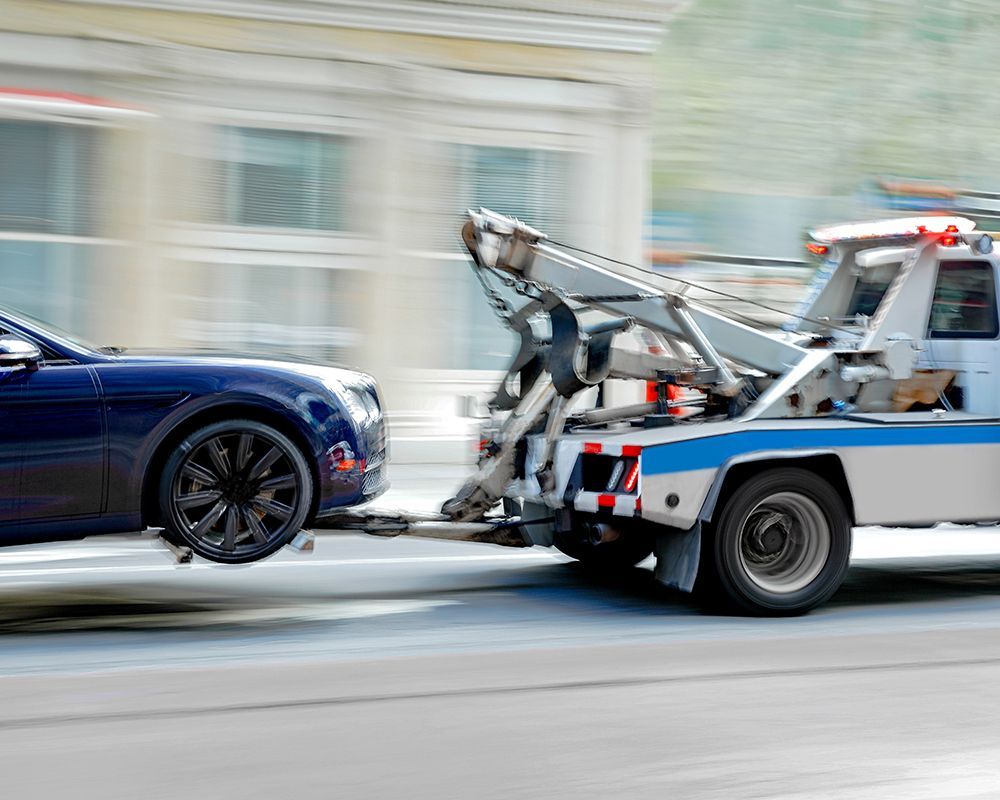 Blue Car is Being Towed using Winching