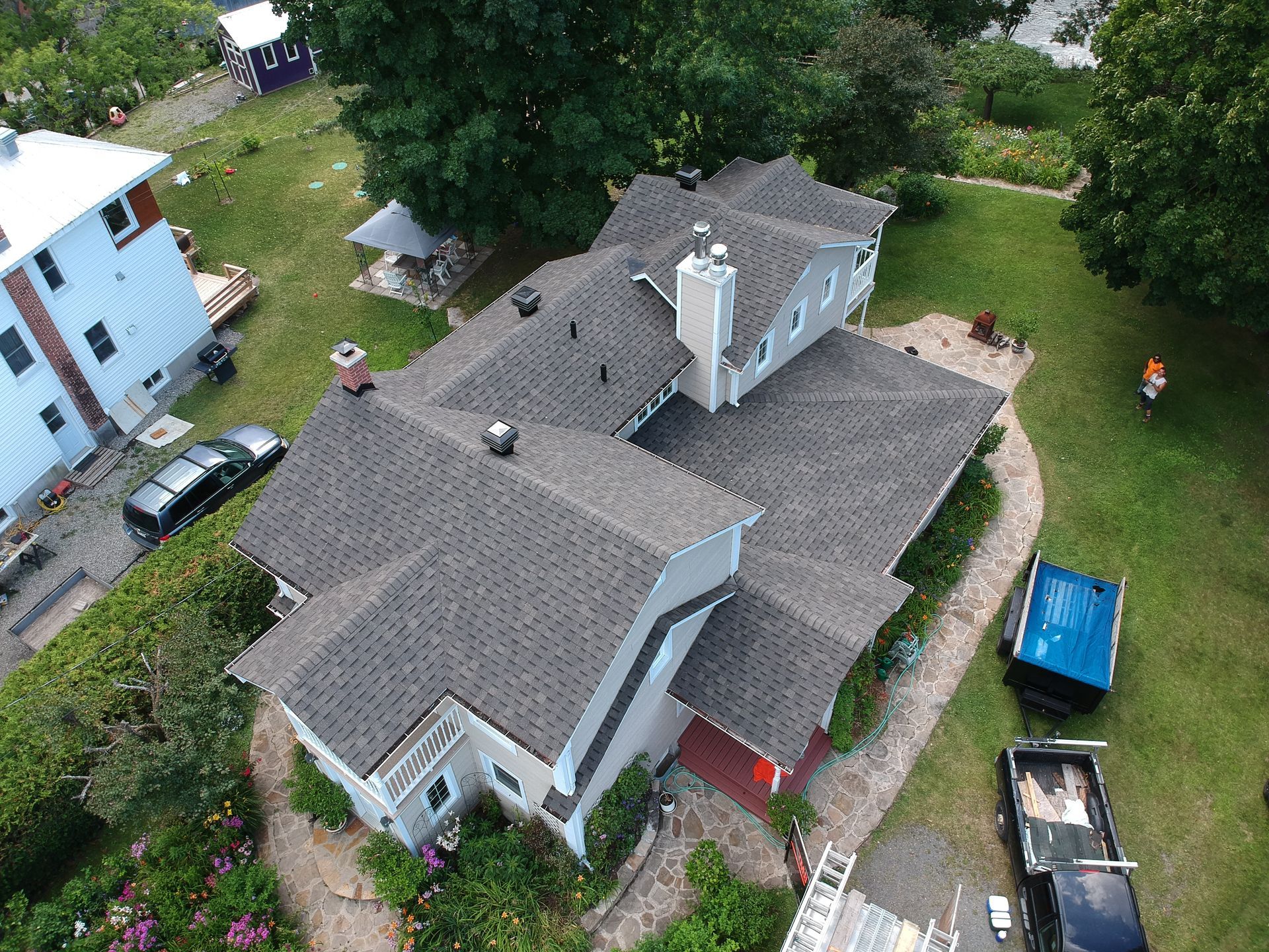 An aerial view of a large house with a new roof.