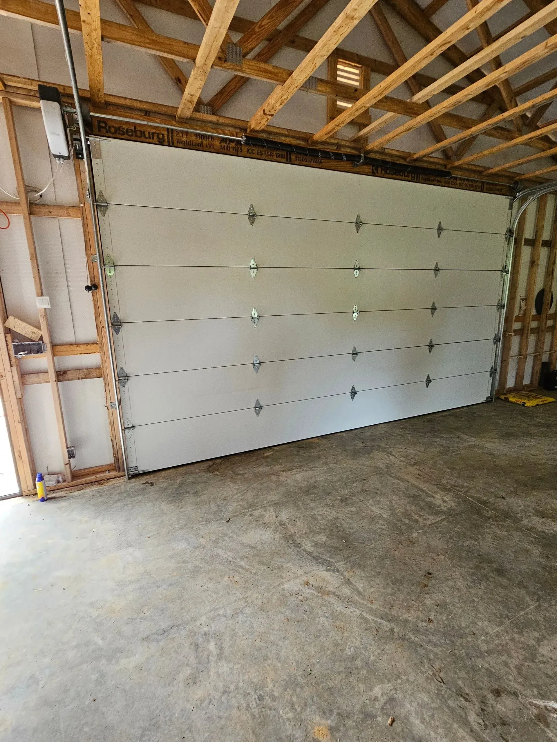 There is a large garage door in the middle of the garage.