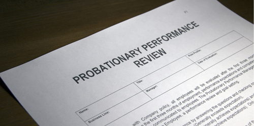 Probationary performance review form on a table.