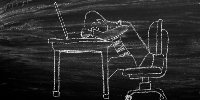 A chalk drawing of a person sleeping at a desk