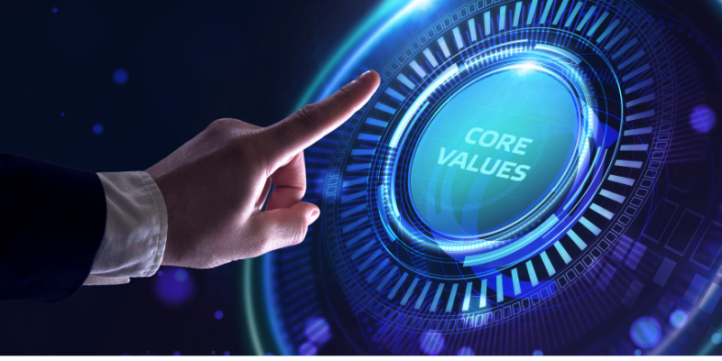 A person is pointing at a screen that says core values.