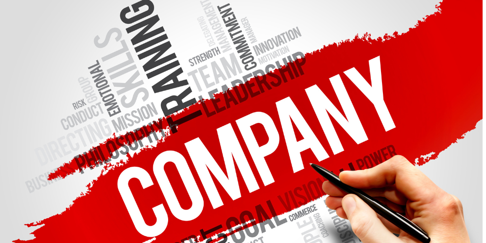 A person is writing the word company on a piece of paper