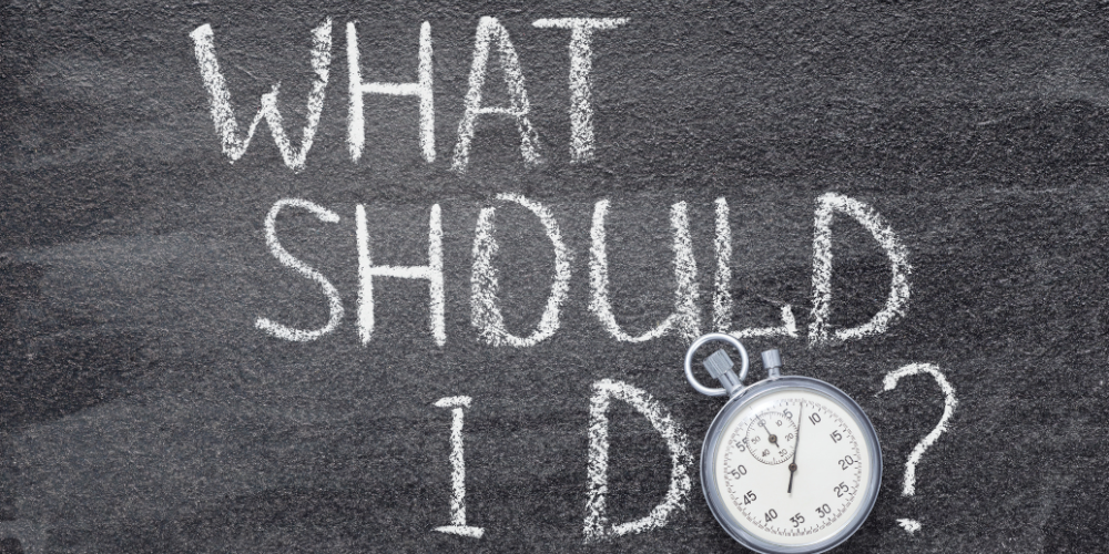 A chalkboard with the words `` what should i do '' written on it.