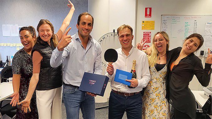 A group of people are posing for a picture in an office.