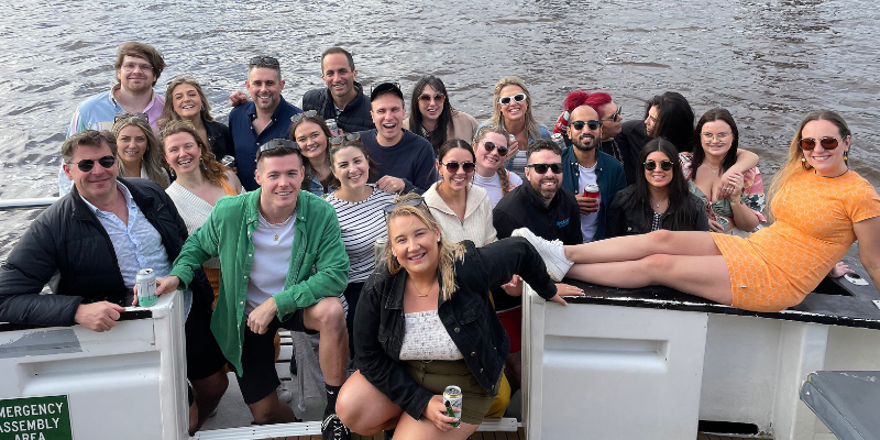 A group of people are posing for a picture on a boat.