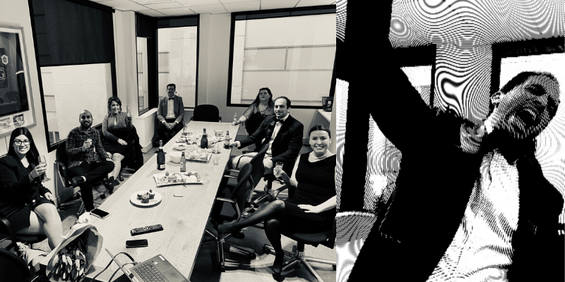 A group of people are sitting around a long table in a conference room.