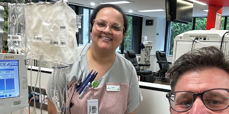 A man and a woman are standing next to each other in a hospital room.