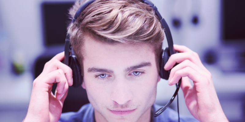 A man wearing headphones with a microphone on his head.