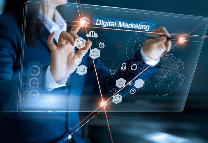 a woman is using a futuristic screen to do digital marketing .