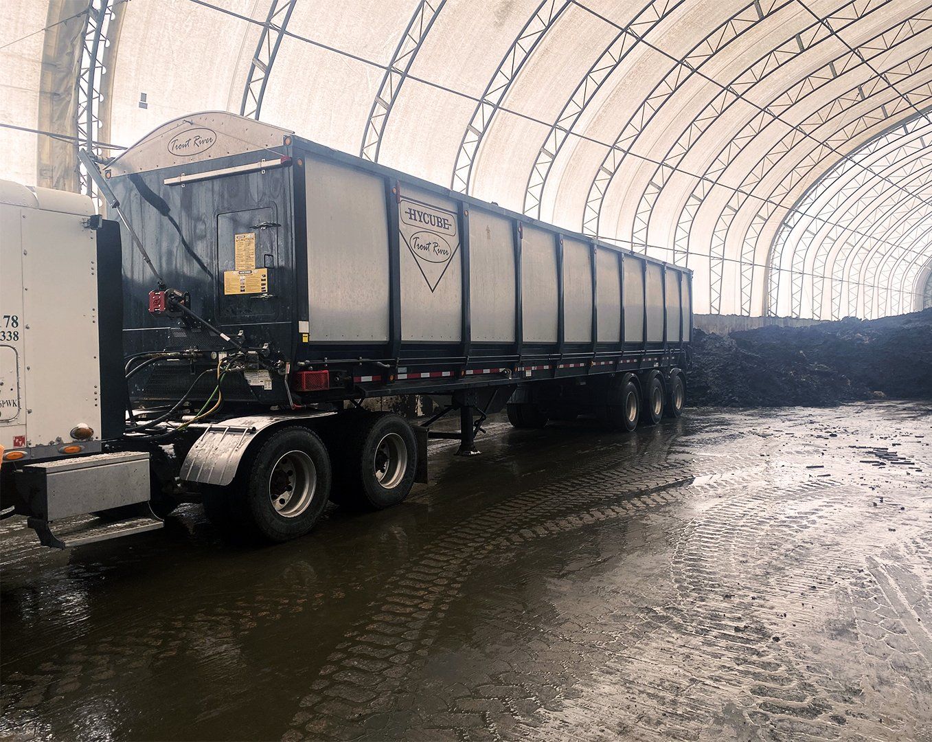 Trout River Industries Hycube trailer in a biosolids warehouse