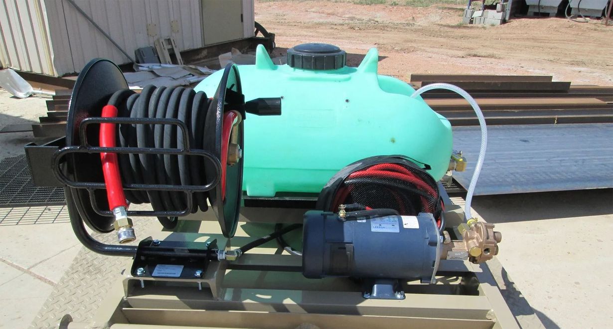 Portable air compressor on a pallet, with a turquoise tank and black motor assembly outdoors.