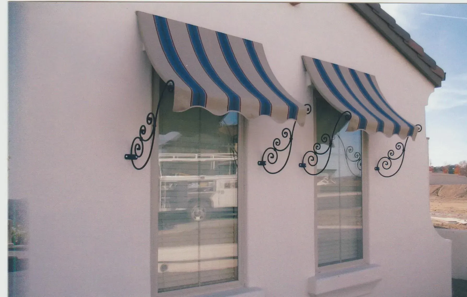 A window with a blue and white awning on it
